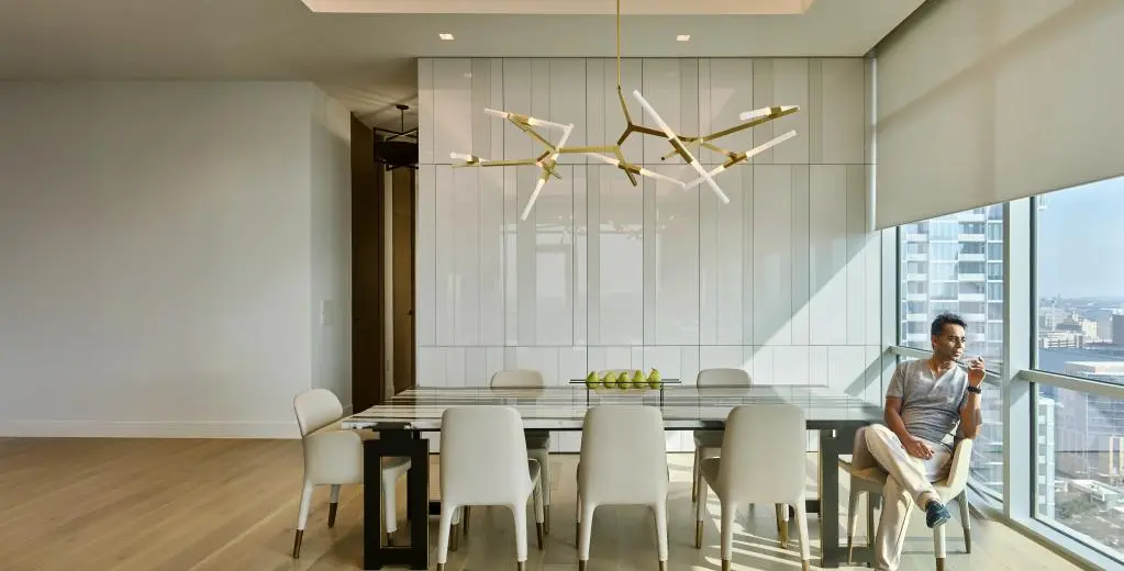 Motorized roller shades in a high-rise dining room